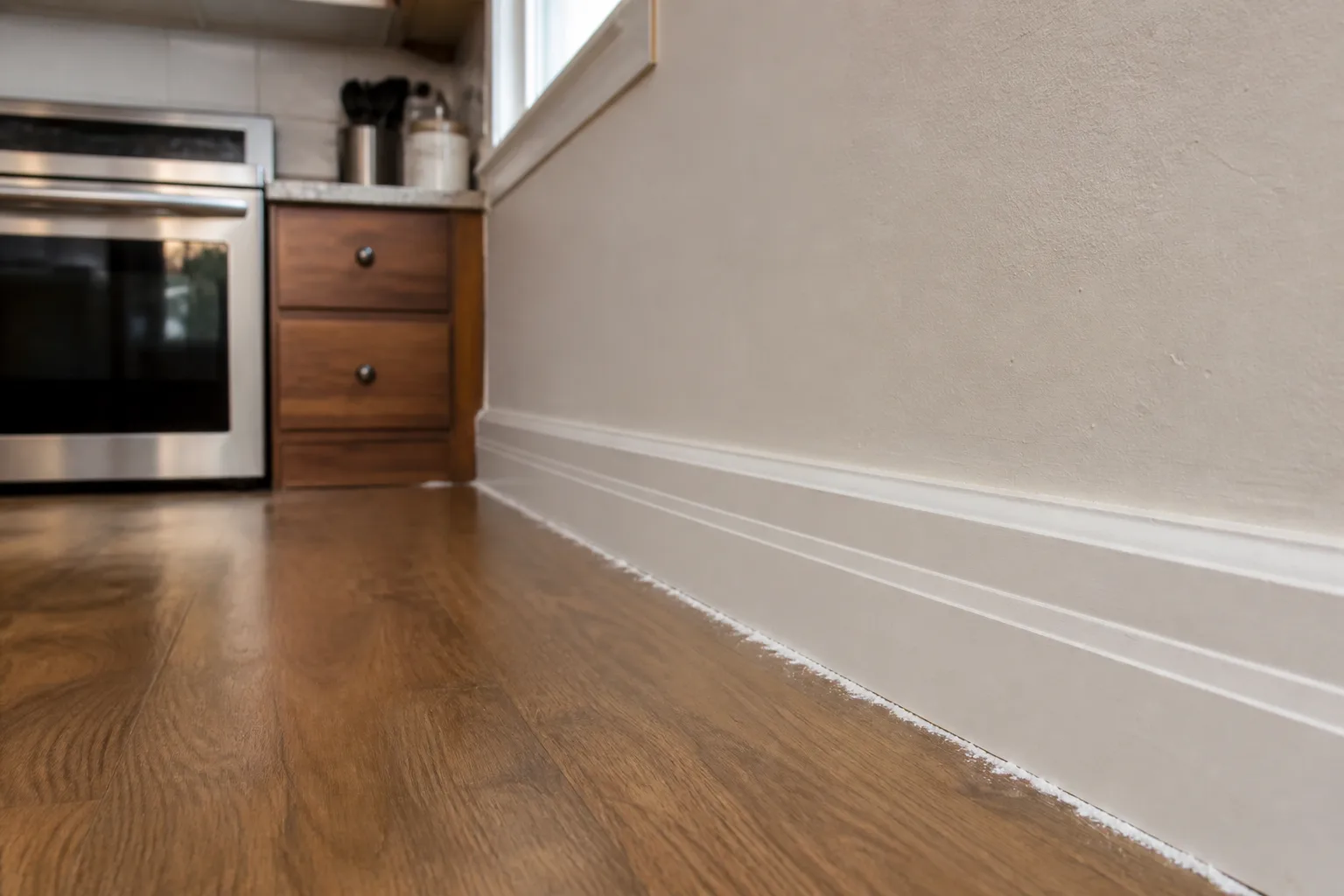 Cockroach control applied along a kitchen baseboard