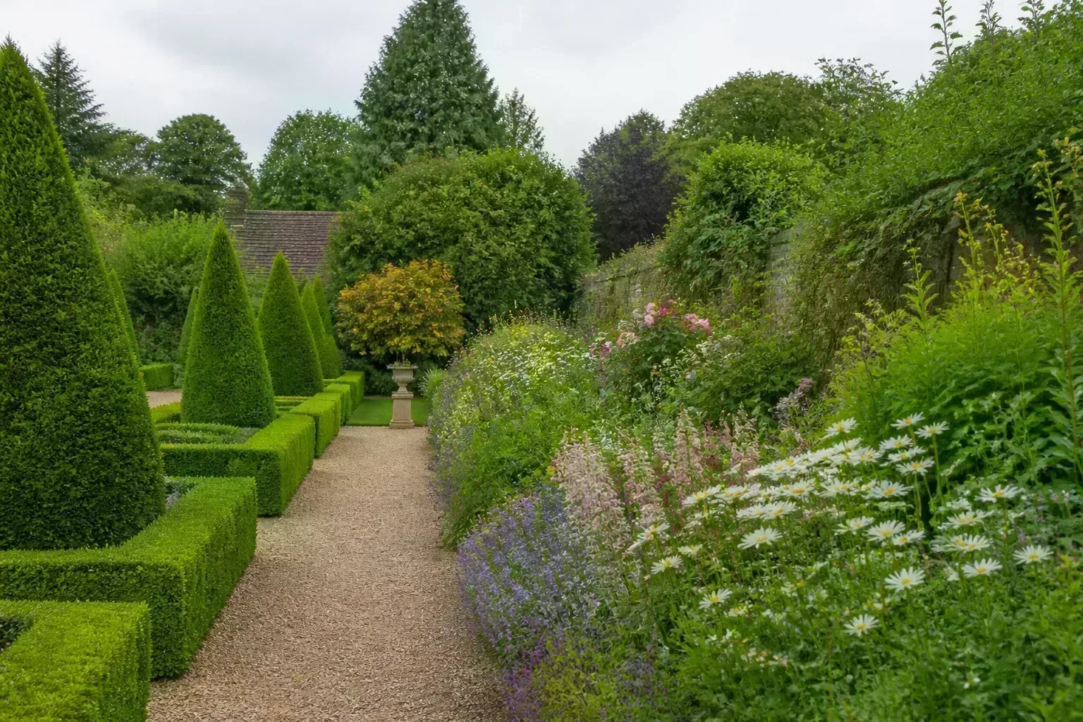 Symmetrical formal garden with clipped hedges and structured European-style lines